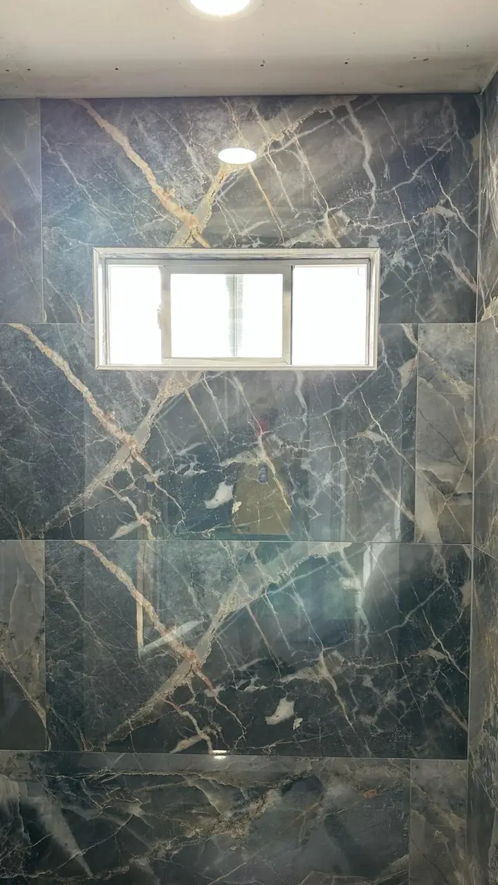 Glass shower with a mosaic stripe